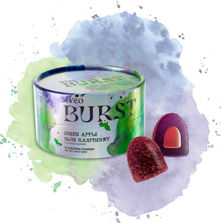 MycoBurst Green Apple Blue Raspberry flavored mushroom gummies in a sleek, iridescent tin, displayed with one whole gummy and one sliced open to reveal a red-orange bursting center, set against a dynamic watercolor background in green, blue, and purple hues.